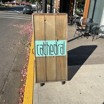 Cathedral Coffee - a wooden sign on a sidewalk - Coffee & Tea Near Me - Scappoose, Oregon