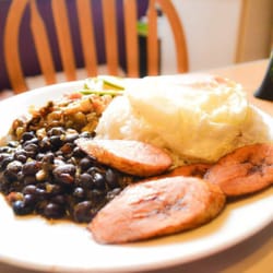 Venezuela cafe - Pabellón Criollo. Traditional Venezuelan meal with rice, pulled beef, black beans, sweet plantain, avocado and an eggs on top of the rice.
