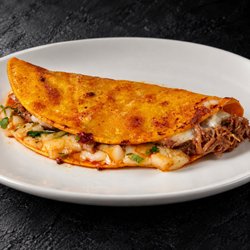Fuego Cravings - 6" corn tortilla taco, filled with melted cheese, tender birria, fresh onion, and cilantro.