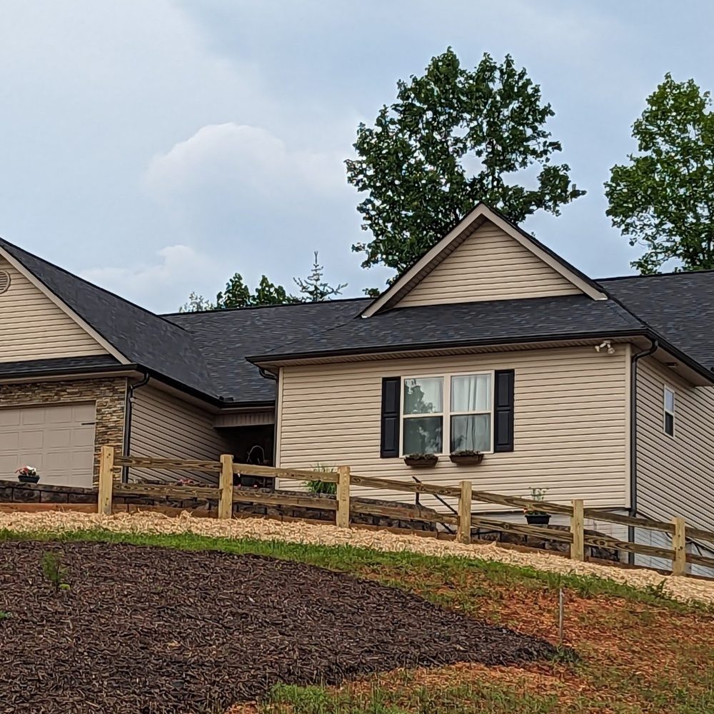 Rooted Landscape Management - a house on a hill - Landscaping Near Me Rooted Landscape Management - a house on a hill - Landscaping Near Me