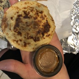 a hand holding a small tortilla