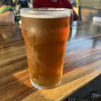 White Squirrel - a glass of beer on a wooden table - Pizza Near Me - Zurich, Ontario