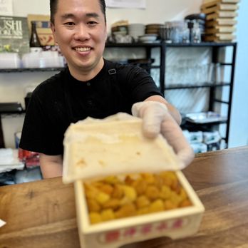 Sushi Kaunta - The chef holding a box of fresh Hokkaido Uni. - Japanese Near Me - Kent, Washington Sushi Kaunta - The chef holding a box of fresh Hokkaido Uni. - Japanese Near Me - Kent, Washington