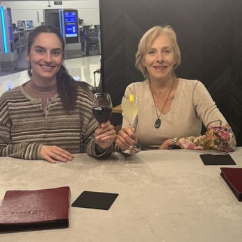 Vino Volo - Mom and daughter waiting on their delayed flight. Happy to have discovered Vino Volo at the Atlanta airport near gate T18 - Wine Bars Near Me - Atlanta, Georgia