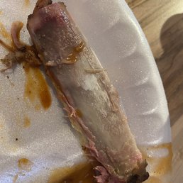 a piece of meat on a paper plate