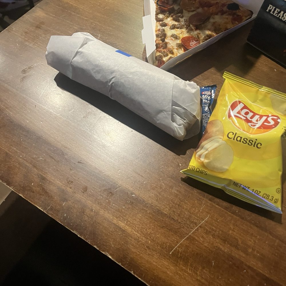 a burrito and chips on a table a burrito and chips on a table