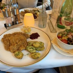 Schlosscafe - Schnitzel and side salad. Comes with potatoes and cranberry sauce