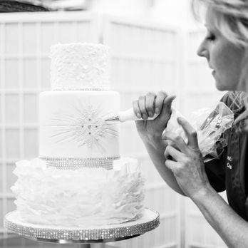 Ambrosia Cake Creations - a woman decorating a wedding cake - Bakeries Near Me Ambrosia Cake Creations - a woman decorating a wedding cake - Bakeries Near Me