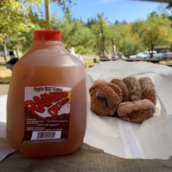 Rainbow Orchards - Cold apple cider and with fresh apple cider donuts on a picnic table under the shade awning - Fruits & Veggies Near Me - Camino, California Rainbow Orchards - Cold apple cider and with fresh apple cider donuts on a picnic table under the shade awning - Fruits & Veggies Near Me - Camino, California