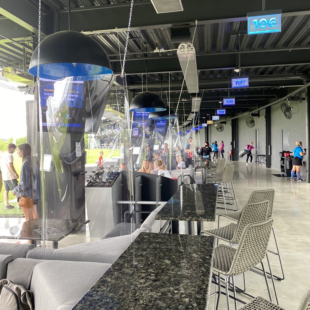Topgolf - Extra bar table behind bay, currently bays are divided by plastic - New American Near Me - Rogers, Arkansas Topgolf - Extra bar table behind bay, currently bays are divided by plastic - New American Near Me - Rogers, Arkansas