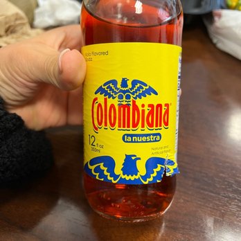 Sardi's Pollo A La Brasa - a hand holding a bottle of colombia - Peruvian Near Me - Laurel, Maryland Sardi's Pollo A La Brasa - a hand holding a bottle of colombia - Peruvian Near Me - Laurel, Maryland