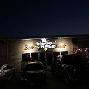 The Watering Hole - the outside of the building at night - Sports Bars Near Me - San Antonio, Texas The Watering Hole - the outside of the building at night - Sports Bars Near Me - San Antonio, Texas