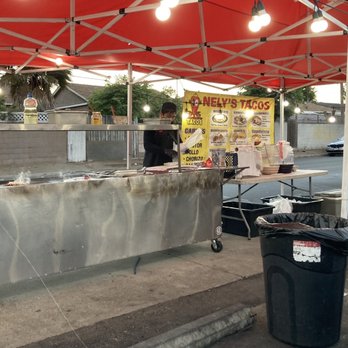 Nely's Tacos - a man standing at a food stand - Mexican Near Me - Los Angeles, California Nely's Tacos - a man standing at a food stand - Mexican Near Me - Los Angeles, California