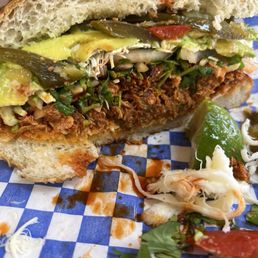 Pollo adobado torta with jalapeños and Oaxaca cheese