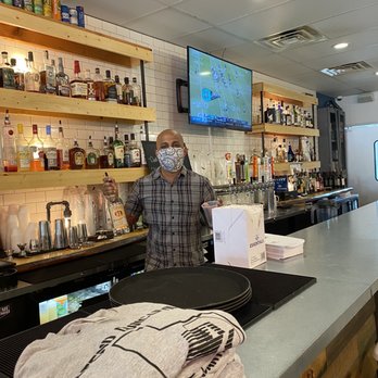 Mudhook Bar & Kitchen - Tristan, the owner in front of the bar - Burgers Near Me - Duncanville, Texas