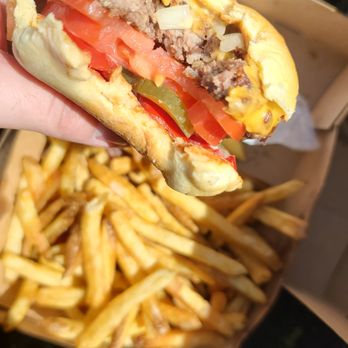 Uniburger - a person holding a sandwich and french fries - Burgers Near Me - Montreal, Quebec Uniburger - a person holding a sandwich and french fries - Burgers Near Me - Montreal, Quebec