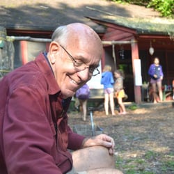 Nature Camps - Early August morning by Lodge -- helping children make gee-haw whimmey diddles.