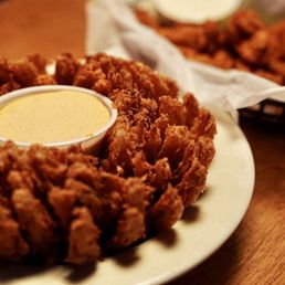 a plate of fried chicken and a bowl of ranch sauce
