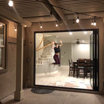 Legendary CalRep Windows and Doors - Bi fold doors with a happy wife jumping for joy! - Windows Installation Near Me - Anaheim, California Legendary CalRep Windows and Doors - Bi fold doors with a happy wife jumping for joy! - Windows Installation Near Me - Anaheim, California