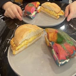 2 Eggs w/ cheese on a roll Beef bacon and cream cheese on a rainbow bagel