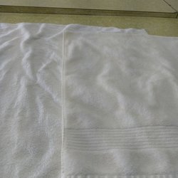 Ladybug Cleaners - Stained. A towel that was missed is underneath the stained towel to show the contrast.