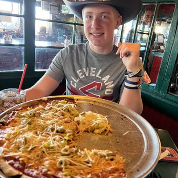 Oregano's - My grandson enjoying his first bite of our amazing pizza! - Pizza Near Me - Tempe, Arizona Oregano's - My grandson enjoying his first bite of our amazing pizza! - Pizza Near Me - Tempe, Arizona