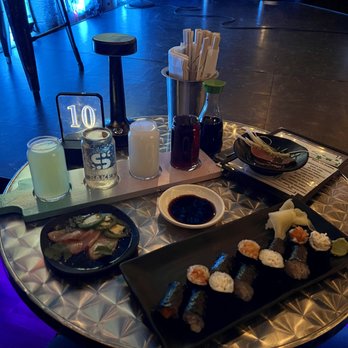 Denver Comedy Lounge - a table with sushi and drinks - Comedy Clubs Near Me - Denver, Colorado Denver Comedy Lounge - a table with sushi and drinks - Comedy Clubs Near Me - Denver, Colorado