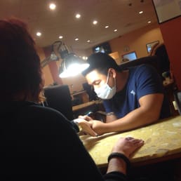 My wife getting new skull nails and sparkles done at her favorite nail place.
