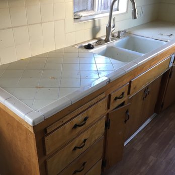 Bathcrest - a kitchen counter with a sink and a window - Flooring Near Me
