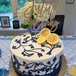 a blue and white cake with lemon slices on top