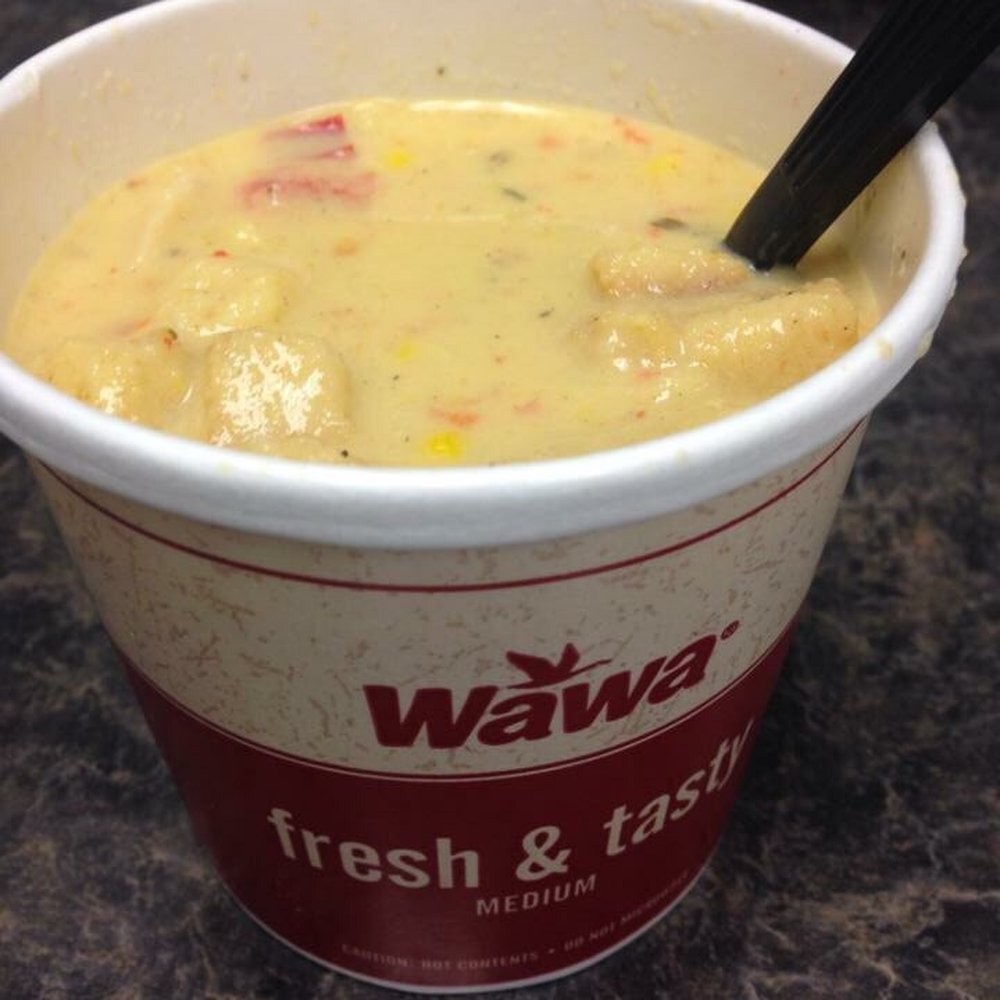 a bowl of soup with a spoon in it a bowl of soup with a spoon in it