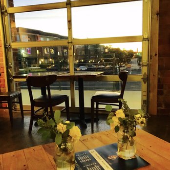 Crown Station - two vases of flowers on a table - Pubs Near Me - Charlotte, North Carolina
