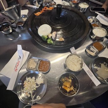The Cast Iron Pot 3 - Accompaniments: soy bean paste and an amazing dipping sauce for the meat - Korean Near Me - Flushing, New York The Cast Iron Pot 3 - Accompaniments: soy bean paste and an amazing dipping sauce for the meat - Korean Near Me - Flushing, New York