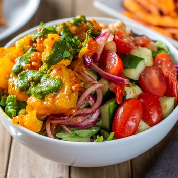 Bombay Eats - Potato Cauliflower over a bed of fresh cut salad + toppings and sauces - Indian Near Me - Chicago, Illinois Bombay Eats - Potato Cauliflower over a bed of fresh cut salad + toppings and sauces - Indian Near Me - Chicago, Illinois