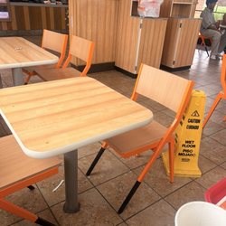 Popeyes Louisiana Kitchen - Dirty dinning room. Tables not cleaned, trash everywhere. Employees standing around.
