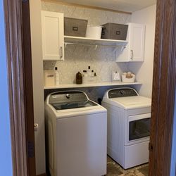 The Kitchen & Bath Company - Laminate countertops, cabinets, and hanging rod.
