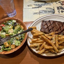 NY strip with a side of garlic fries and a side salad NY strip with a side of garlic fries and a side salad