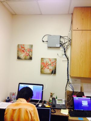 Photo of 3Packet.com - Anaheim, CA, US. No space in closet or cabinet so we posted it on the wall.  That's me below programming the system and phones.