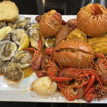 What The Crab - Boiled Crawfish + Lobster Tails in Wat the Cajun Hot flavor, flame buttered oysters - Seafood Near Me - Mansfield, Texas What The Crab - Boiled Crawfish + Lobster Tails in Wat the Cajun Hot flavor, flame buttered oysters - Seafood Near Me - Mansfield, Texas