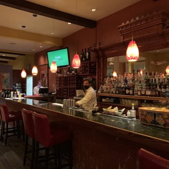 Tempranillo - a restaurant with a bar with red chairs - Spanish Near Me - Basalt, Colorado