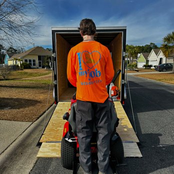 Koch Garden Palms Landscaping - a man loading a lawn mower - Landscaping Near Me Koch Garden Palms Landscaping - a man loading a lawn mower - Landscaping Near Me