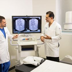 California Sports & Spine Institute - Dr. Revik Vartanian and Dr. Max Moradian discussing a procedure.