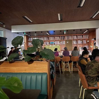The Overland - a group of people sitting in a restaurant - Cocktail Bars Near Me - Redlands, California