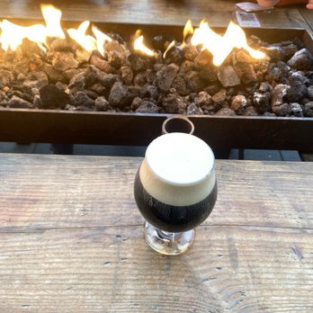 Icicle Brewing - Enjoying a Darker Persuasion Carmel Macchiato on the patio 9 ABV and a fire keeping us warm! - Brewpubs Near Me - Leavenworth, Washington