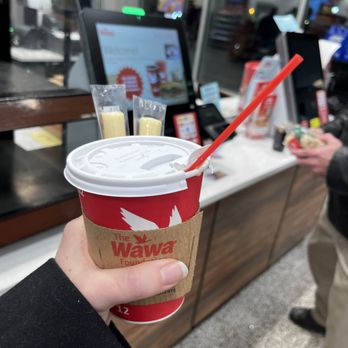 Wawa - a hand holding a cup of coffee - Convenience Stores Near Me - Abington, Pennsylvania
