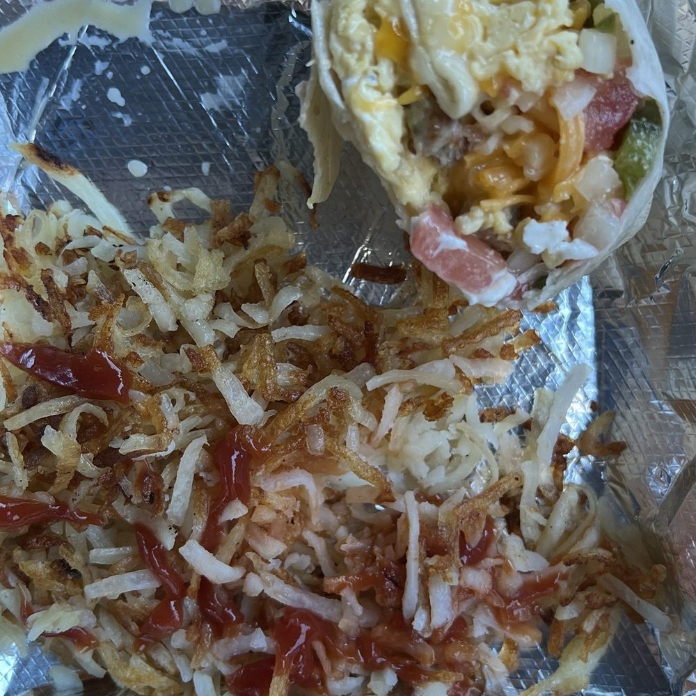 Sippin Cow - Only half of an order of the Bull Burrito and hash browns. I dug in so quick and then remembered to take a picture. It's so good! - American Near Me - Bluffton, South Carolina