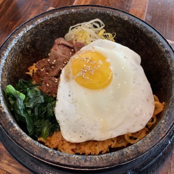 Burning Rice - Hot Stone Pot: kimchi rice, spicy bulgogi, bean sprouts, carrots, egg, and spinach - Korean Near Me - Frisco, Texas