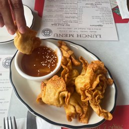 a person dipping dipping sauce onto fried food a person dipping dipping sauce onto fried food