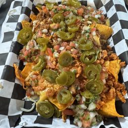 Half chicken half beef nachos, sour cream on the side Half chicken half beef nachos, sour cream on the side