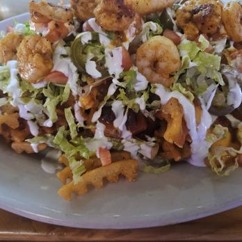 The Pony Inn - Waffle fry nachos with shrimp - Sports Bars Near Me - Chicago, Illinois The Pony Inn - Waffle fry nachos with shrimp - Sports Bars Near Me - Chicago, Illinois